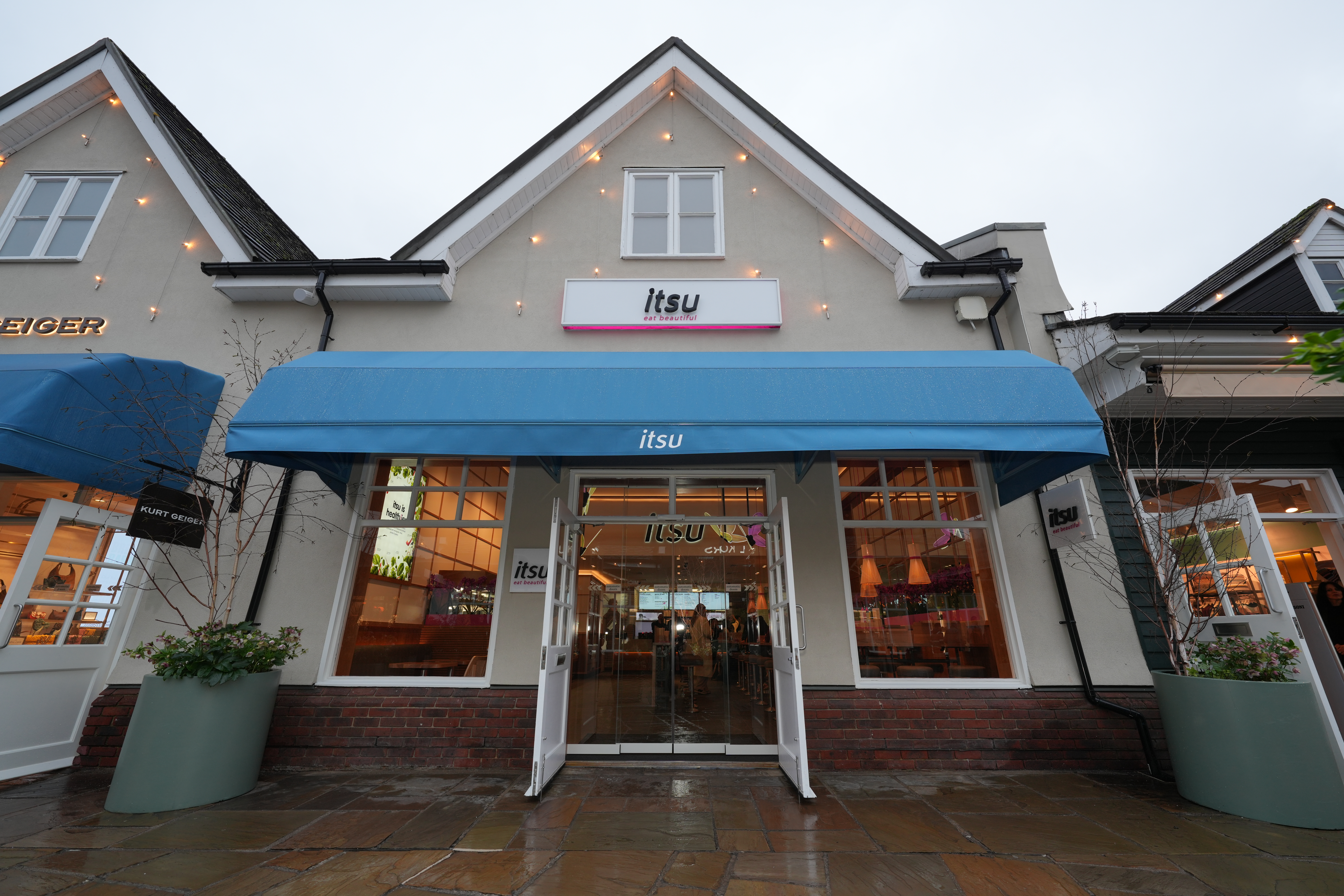 ITULU restaurant exterior with a large blue awning and inviting open entrance.