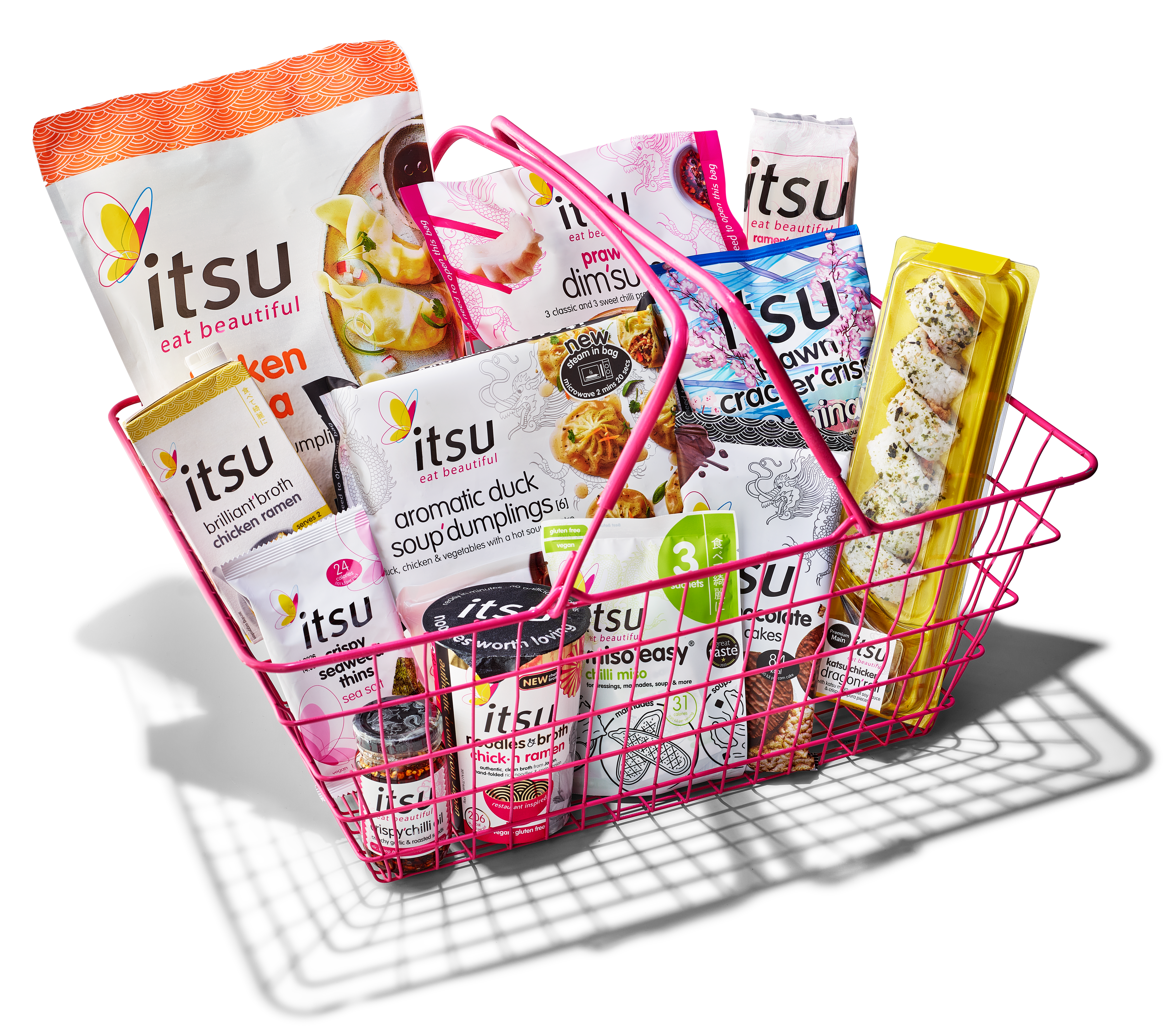 A pink wire basket brimming with a variety of Itsu brand Asian-inspired food products.