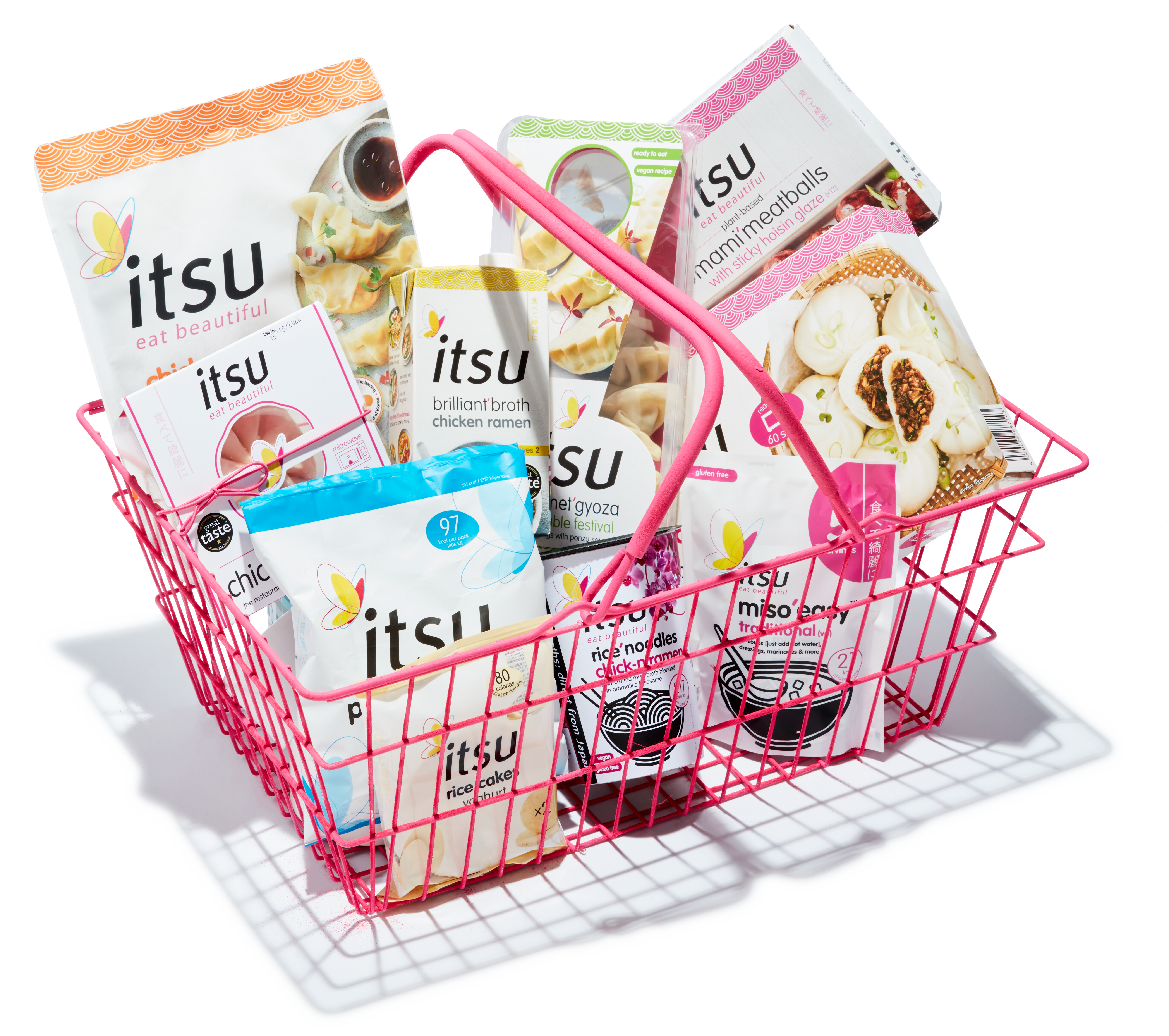 A pink shopping basket filled with a variety of Itsu brand Asian-inspired food products.