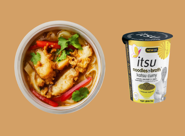 Bowl of katsu curry noodles with chicken and peppers next to its instant packaging cup.