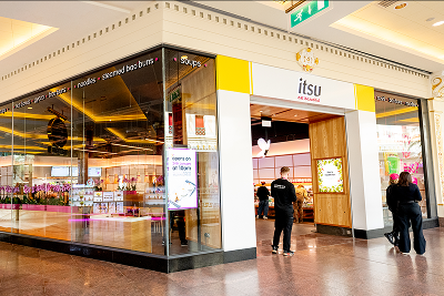 itsu restaurant exterior in a modern shopping mall with large glass windows and entrance.