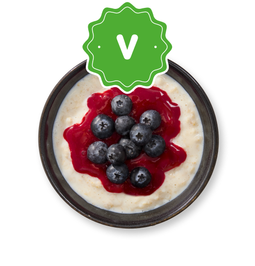 Creamy porridge with berry sauce and blueberries, featuring a green V logo.