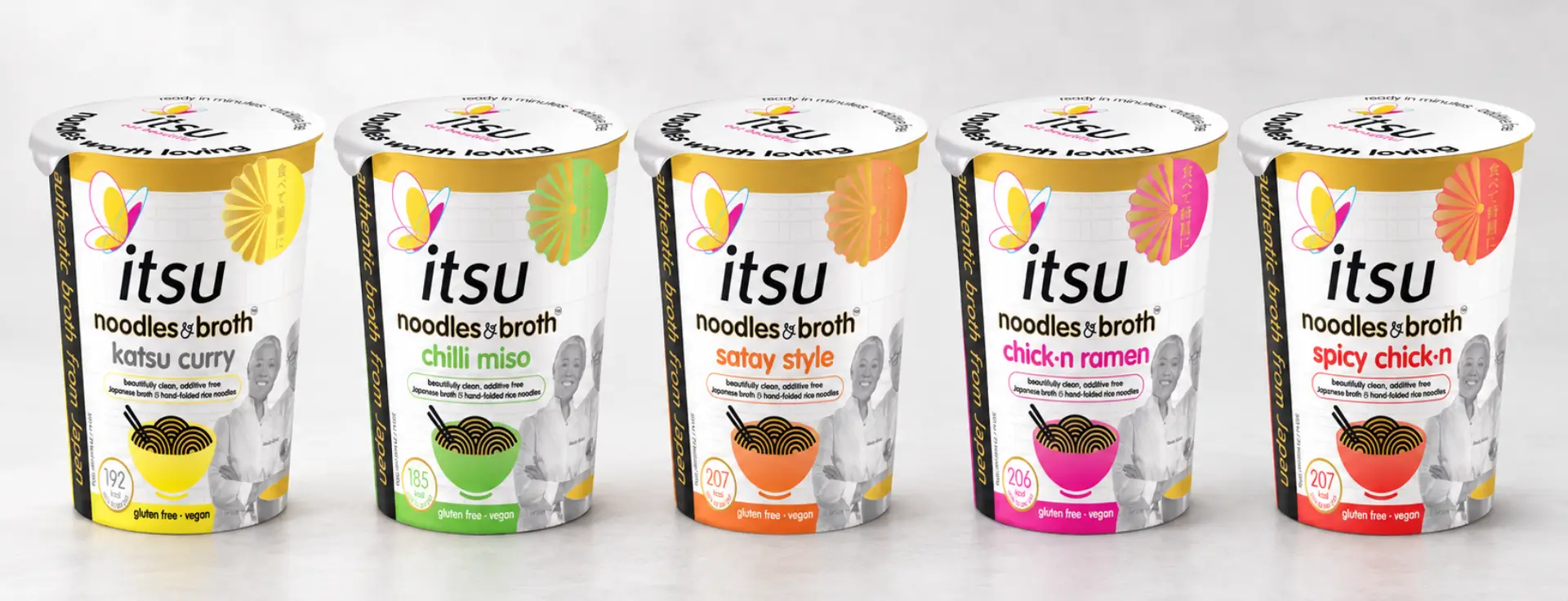 Five itsu Noodles & Broth pots in various flavors, including katsu curry and spicy chicken.