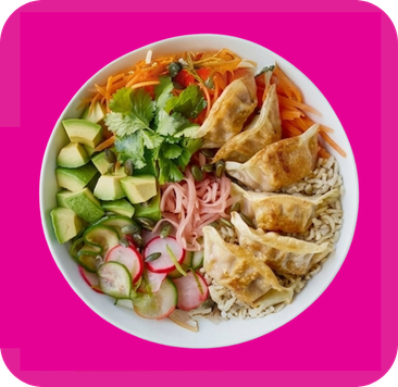 A colorful food bowl featuring crispy dumplings, fresh vegetables, and grains.