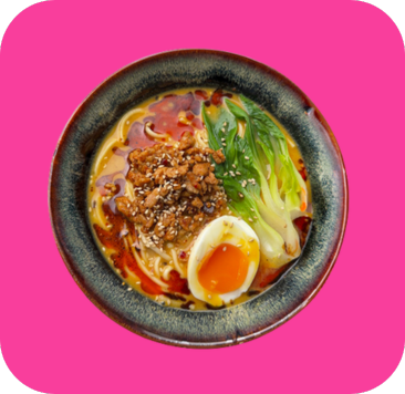 Vibrant ramen bowl with noodles, minced pork, bok choy, and a soft-boiled egg.