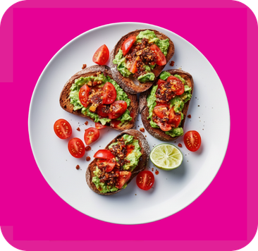 Four slices of avocado toast topped with diced tomatoes and seasoning, served on a white plate.