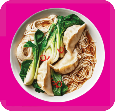 A delicious bowl of dumpling noodle soup with bok choy and chili peppers.