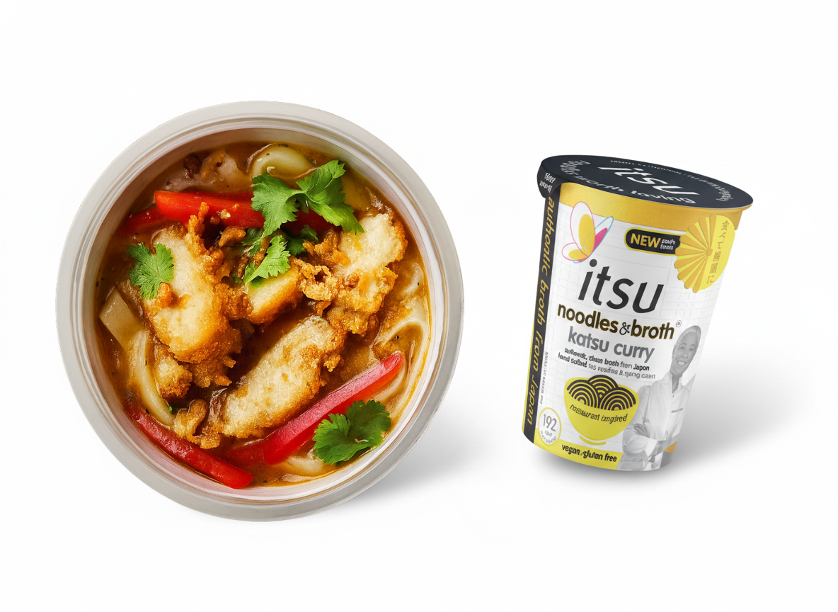 Katsu curry noodles with chicken, peppers, cilantro in bowl, beside an Itsu instant curry cup.
