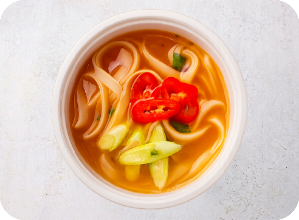 Spicy seafood noodle soup with thick noodles, red chilies, and green onions.