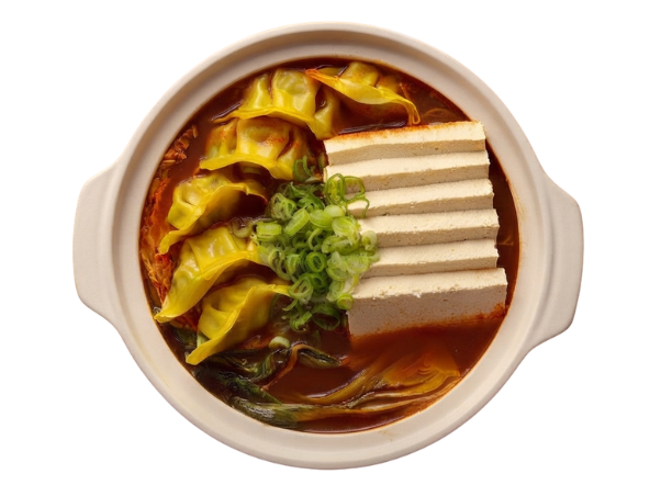Spicy Korean stew with golden dumplings, sliced tofu, and fresh green onions in a ceramic pot.