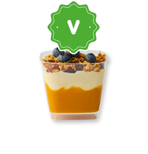 Layered mango dessert with yogurt, granola, and blueberries, with a green V badge.
