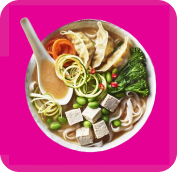 A colorful bowl of miso soup with tofu, dumplings, edamame, and fresh vegetables.