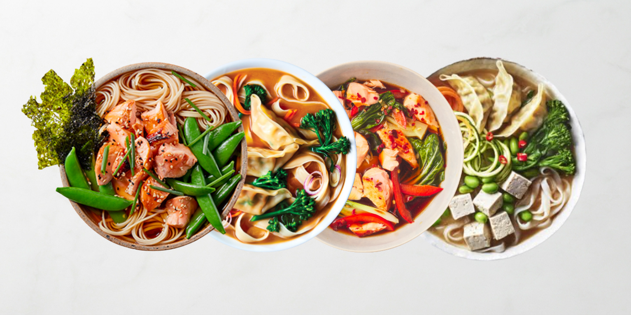 Four vibrant bowls of Asian-inspired noodle soups with salmon, shrimp, dumplings, and fresh vegetables.