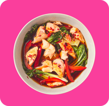 Salmon pieces with bok choy and red bell peppers in a rich dark sauce.