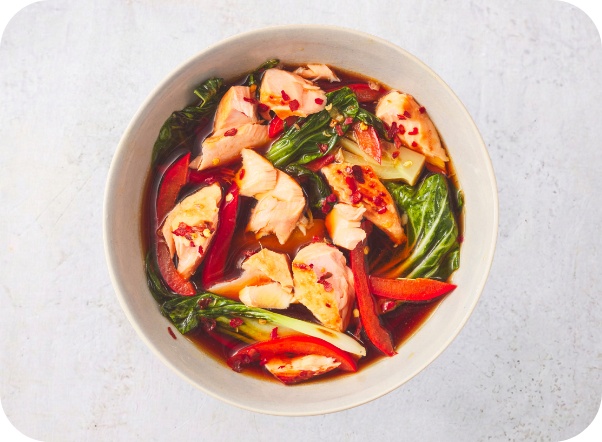 Chicken with bok choy and red peppers in a savory, chili-flaked sauce.