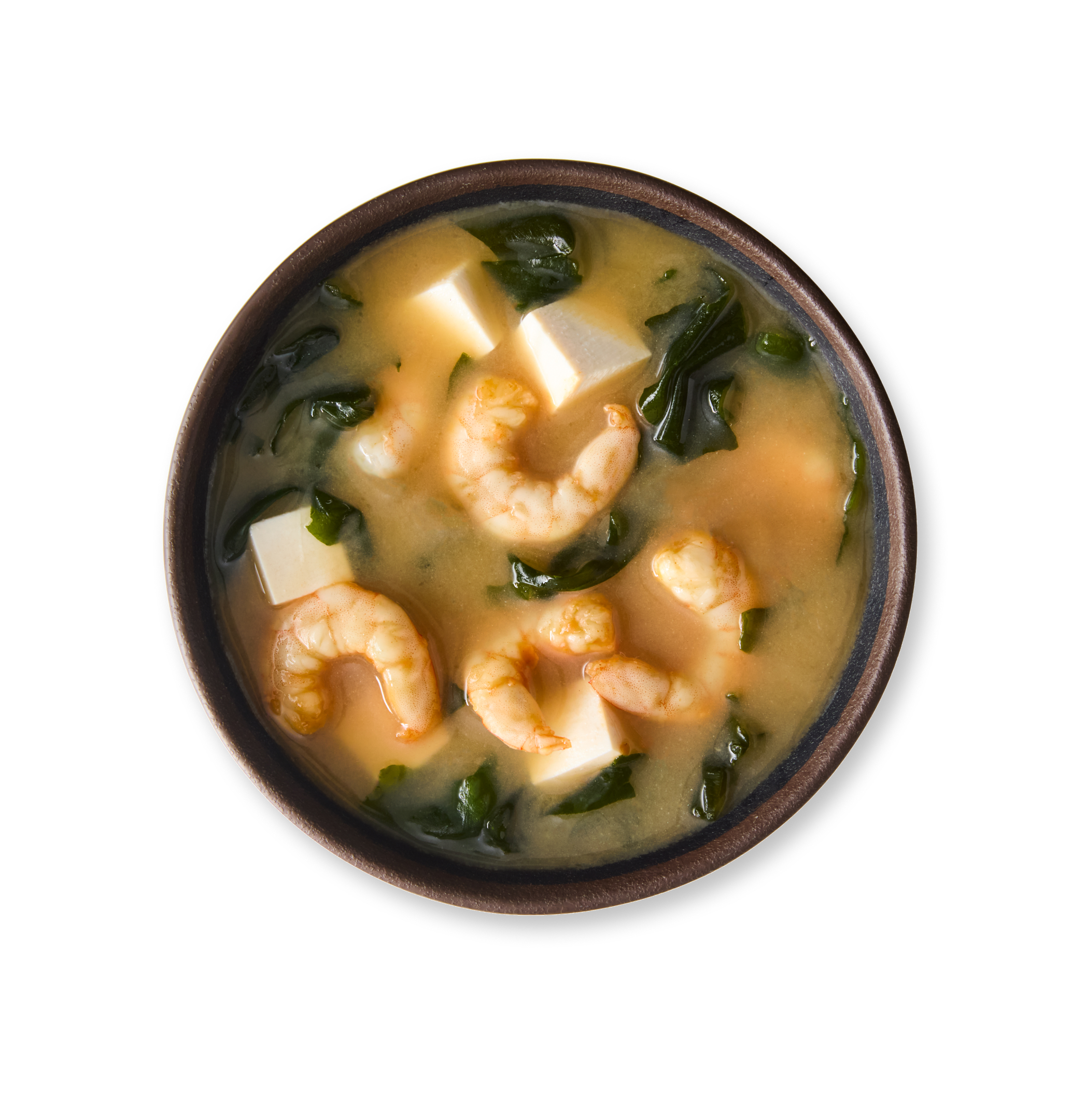 A bowl of miso soup with shrimp, tofu, and seaweed.