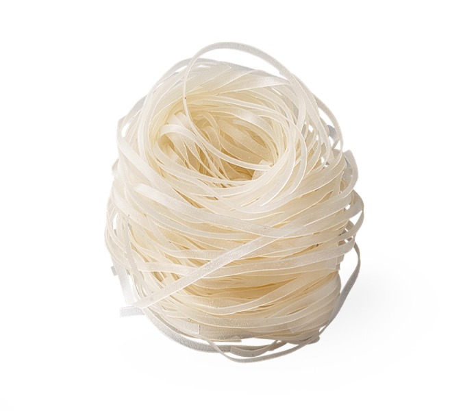A nest of translucent, uncooked rice vermicelli noodles sits on a white background.