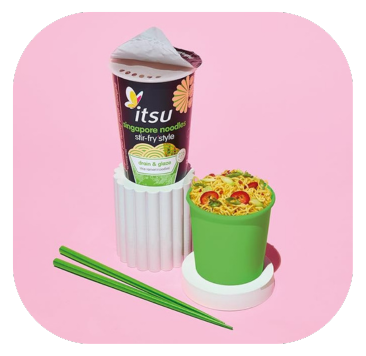 Itsu instant noodle cup and a bowl of cooked noodles with green chopsticks on a pink background.