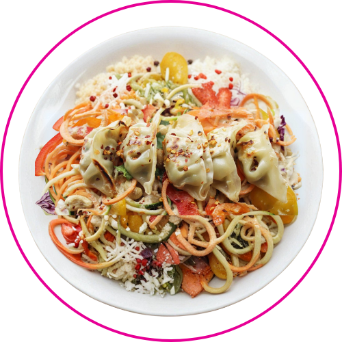 A vibrant bowl of rice topped with spiralized vegetables, colorful peppers, and five dumplings.
