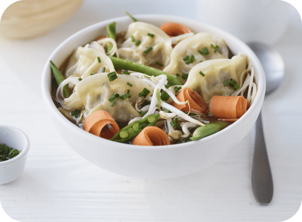 White bowl of dumpling soup with green beans, shredded carrots, and bean sprouts.