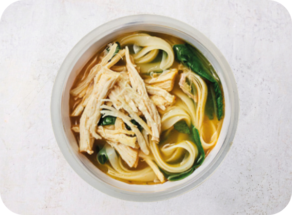 Bowl of chicken noodle soup with shredded chicken, wide noodles, and green vegetables.