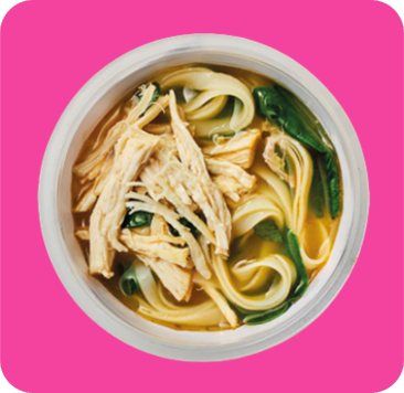 A white bowl of chicken noodle soup with shredded chicken, flat noodles, and greens.