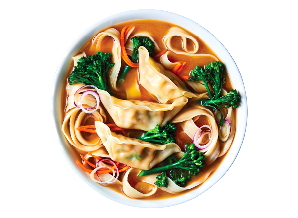A vibrant bowl of savory dumplings, curly noodles, broccoli, and red onions in broth.