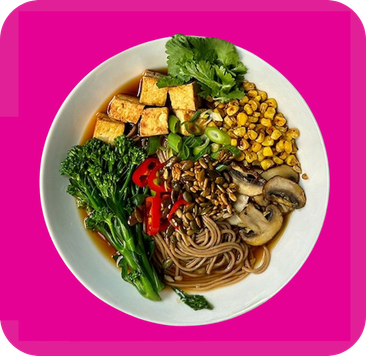 Soba noodle bowl featuring crispy tofu, roasted corn, steamed broccoli, and fresh herbs.
