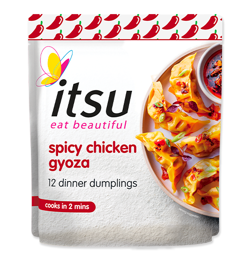 itsu spicy chicken gyoza package with cooked dumplings on a plate.