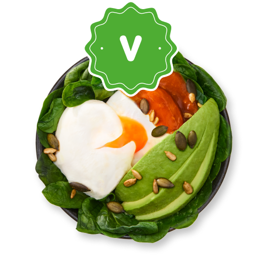 Nutritious vegetarian bowl with poached egg, sliced avocado, spinach, and mixed seeds.