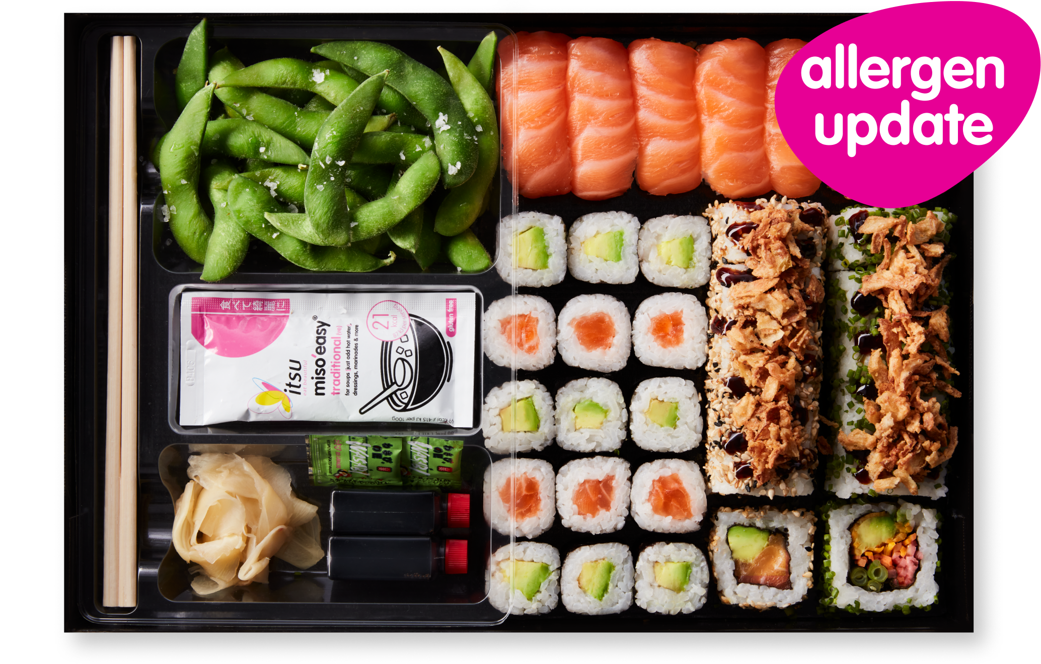Bento box with salmon sushi, maki rolls, edamame, ginger, and soy sauce.