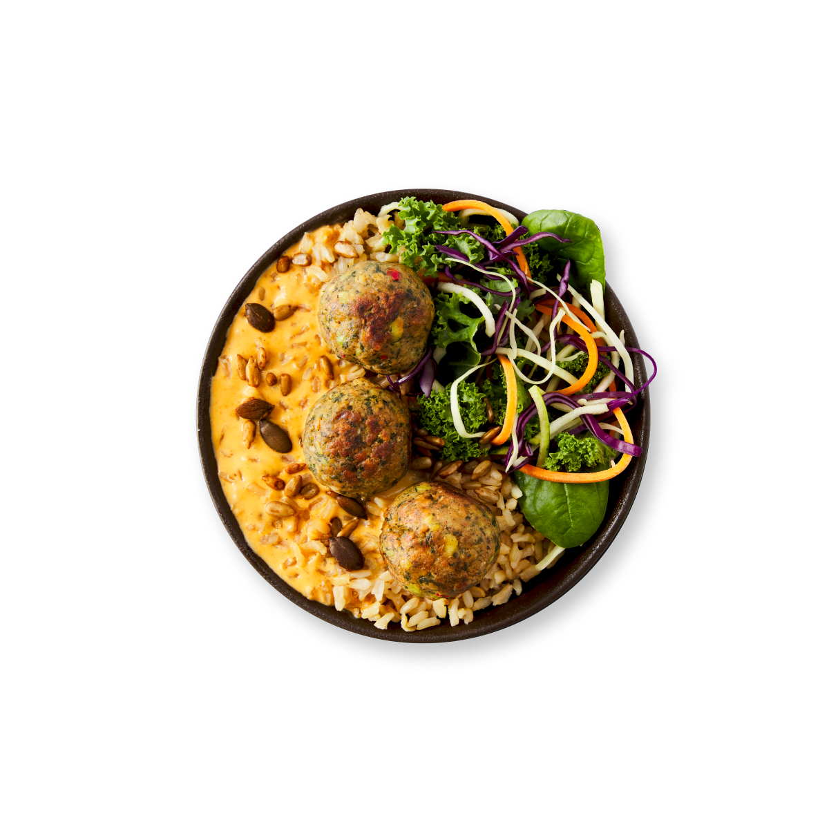 A bowl featuring three meatballs, creamy orange sauce, grains, and a fresh salad.